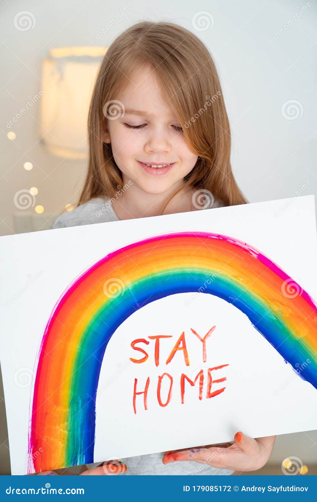 small girl drew rainbow and poster stay home.