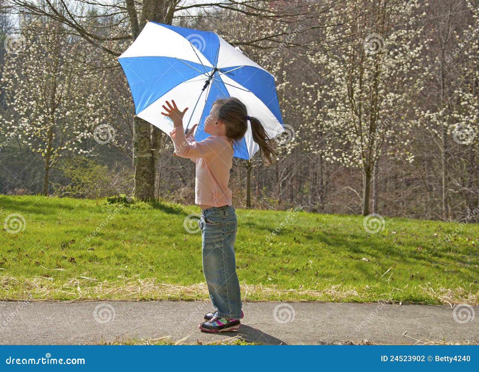 Small Girl Playing with Umbrella on Windy Day. Stock Photo Image of