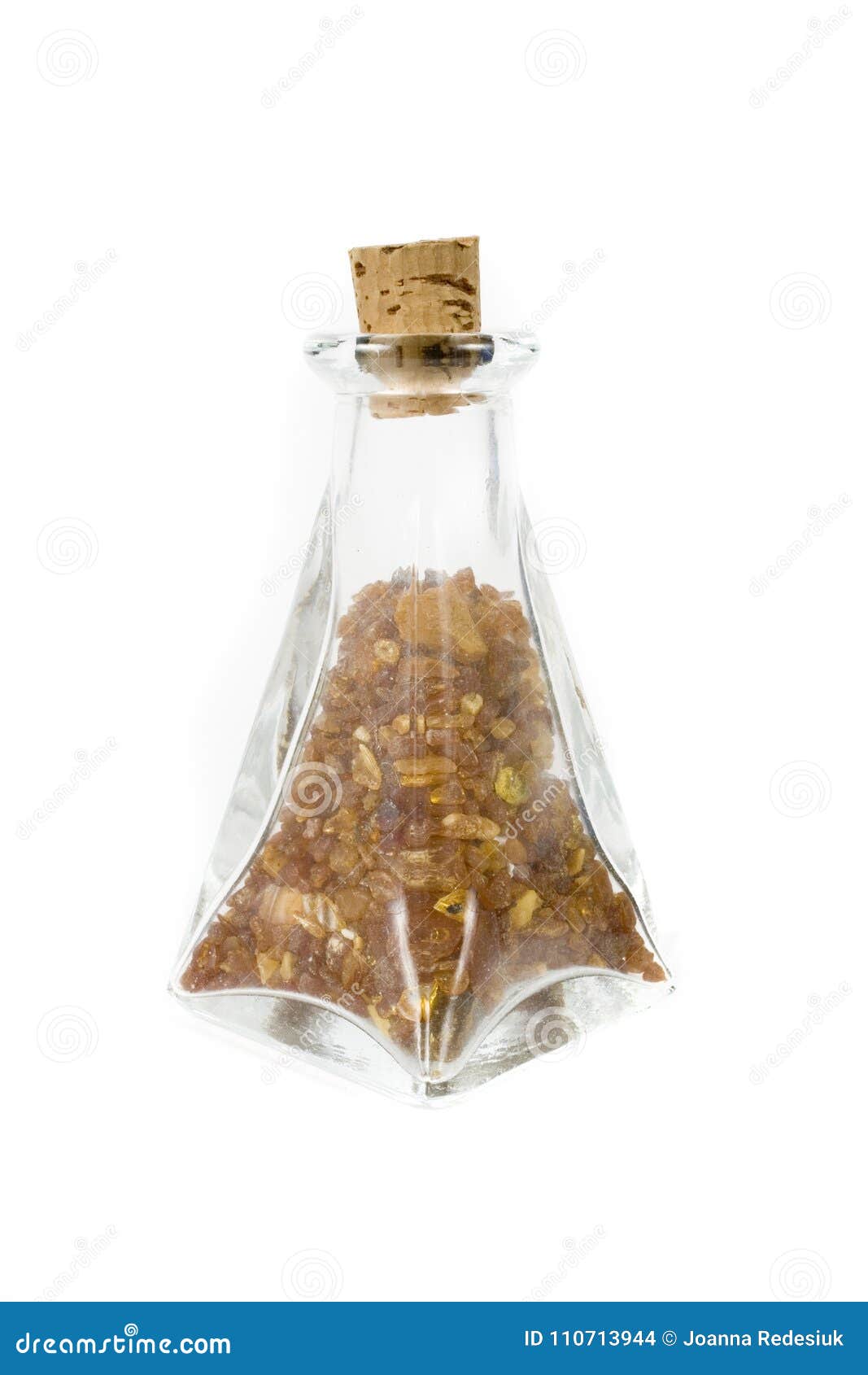 A Glass Container Full of Ambers on a White Isolated Background Stock