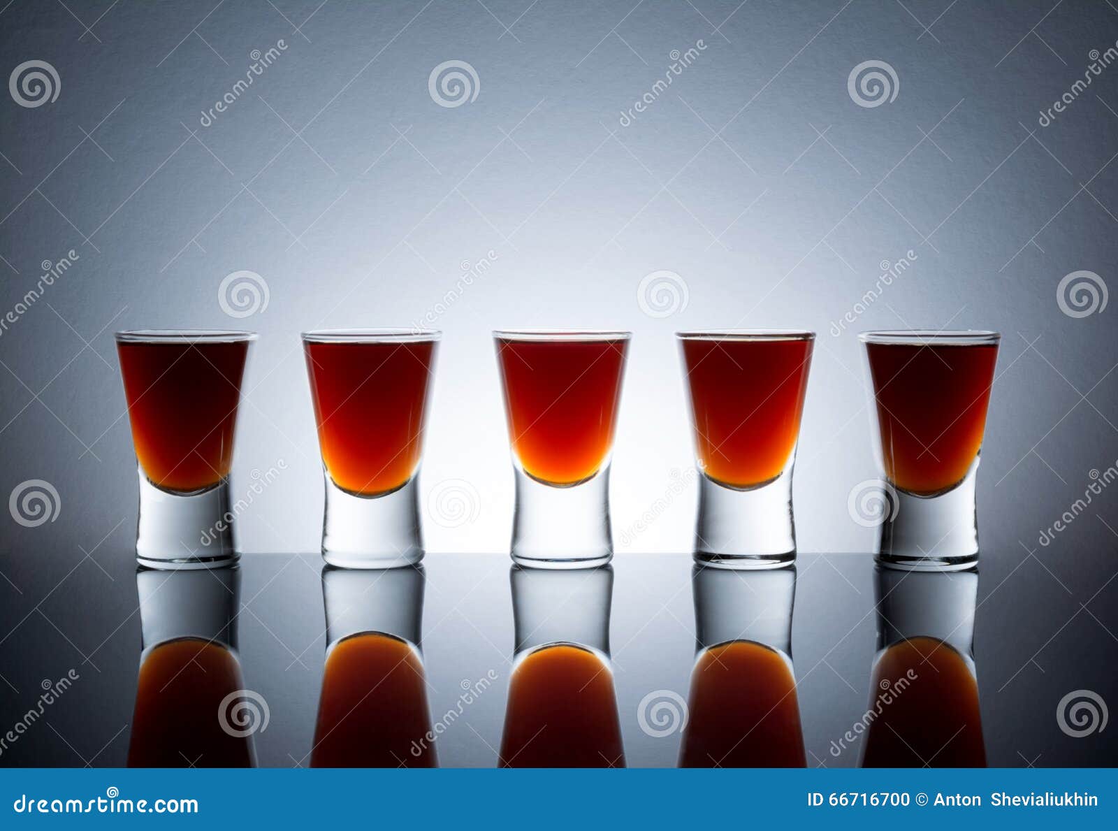 Small Glasses, Drink Shots of Alcohol with Reflection Stock Photo