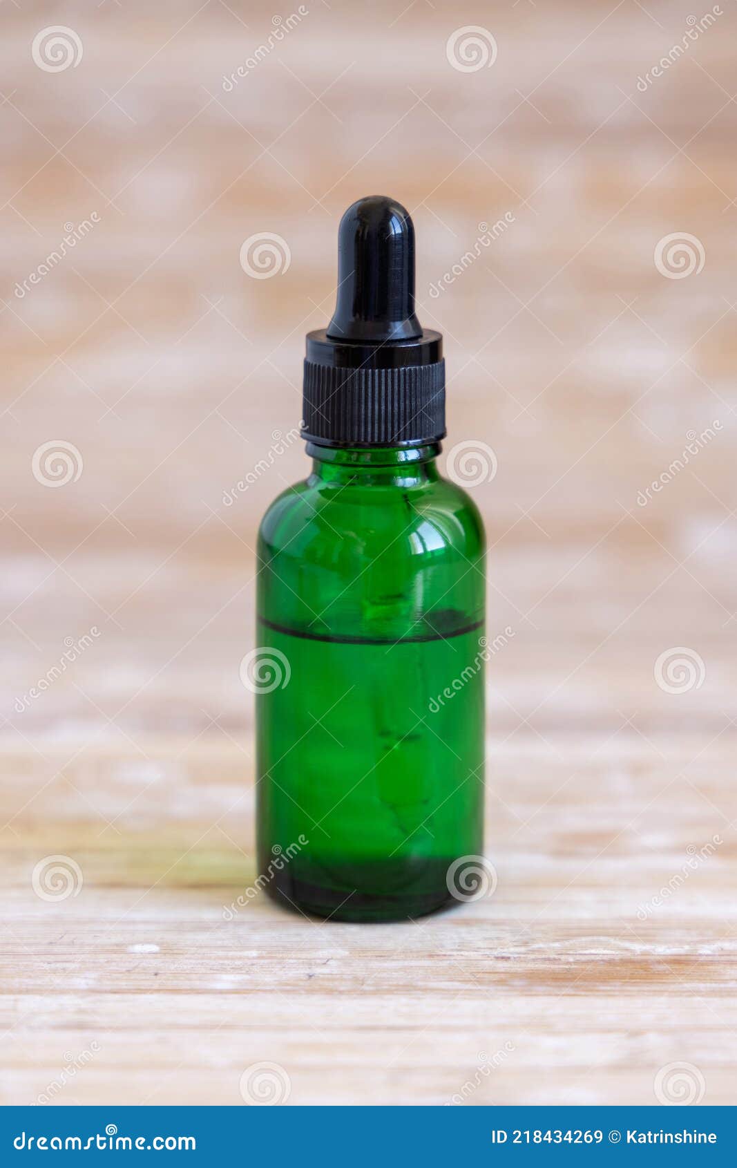 A Small Green Bottle with a Dropper Full of Essential Oil Stock Image