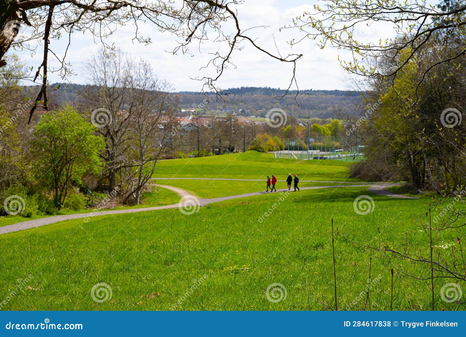 Small Group of People Wandering on a Path through a Green Park.. Stock ...