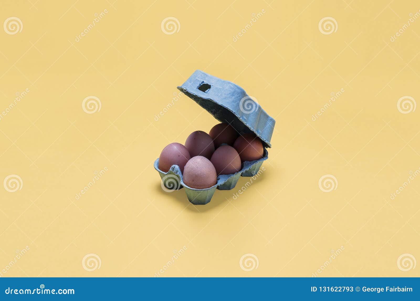 Small Half Dozen Organic Free Range Brown Eggs in an Open Egg Carton