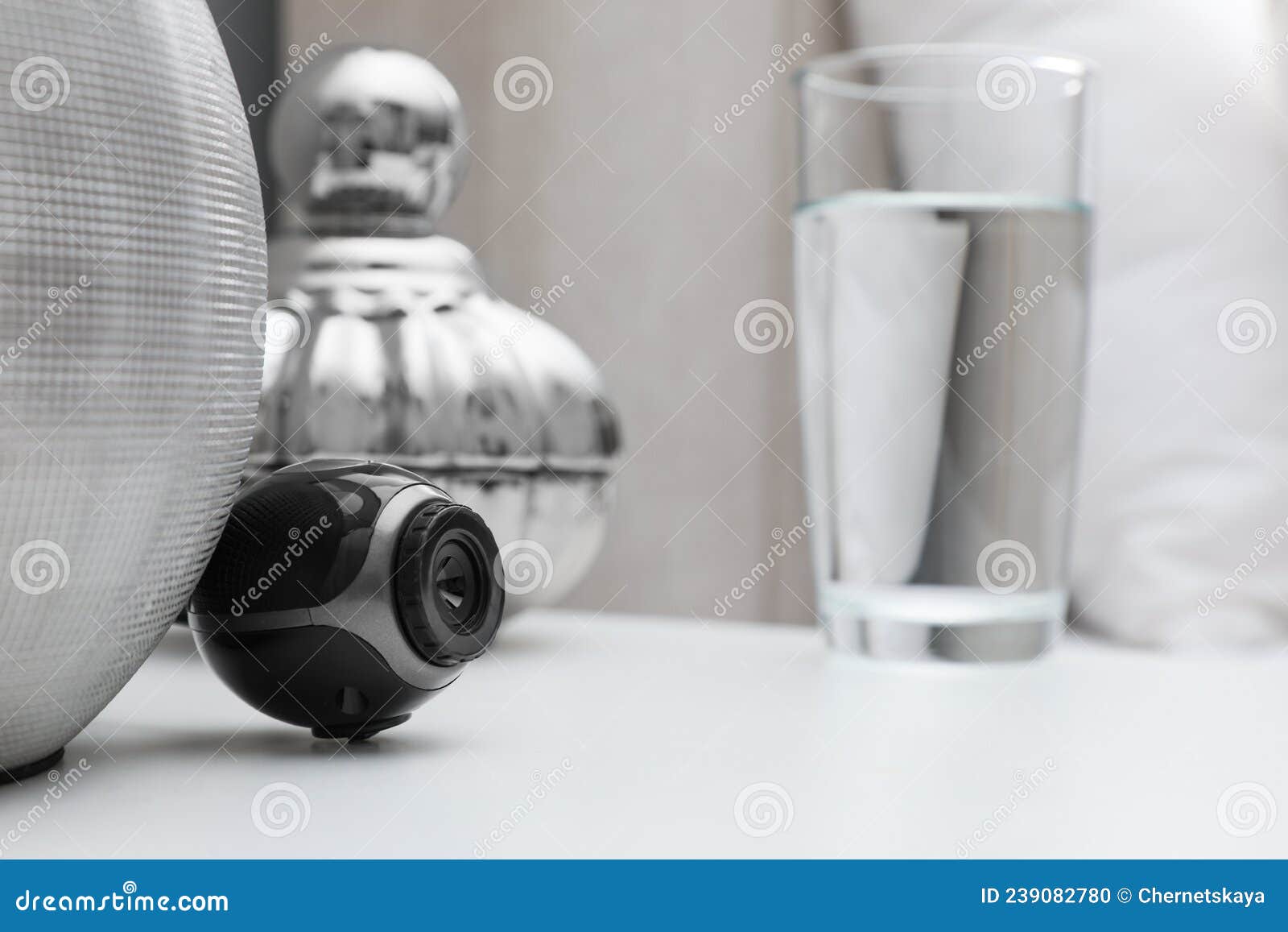 small hidden camera on white nightstand in bedroom