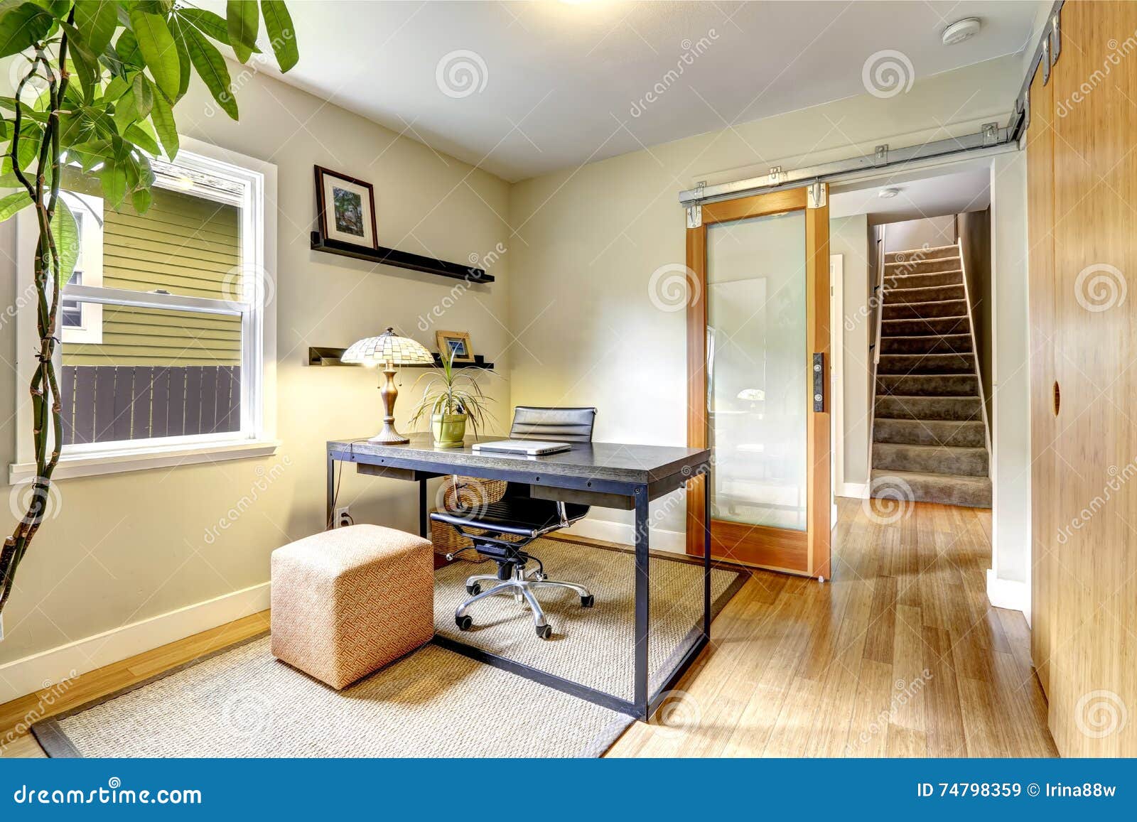 small home office interior with hardwood floor. view of staircase.