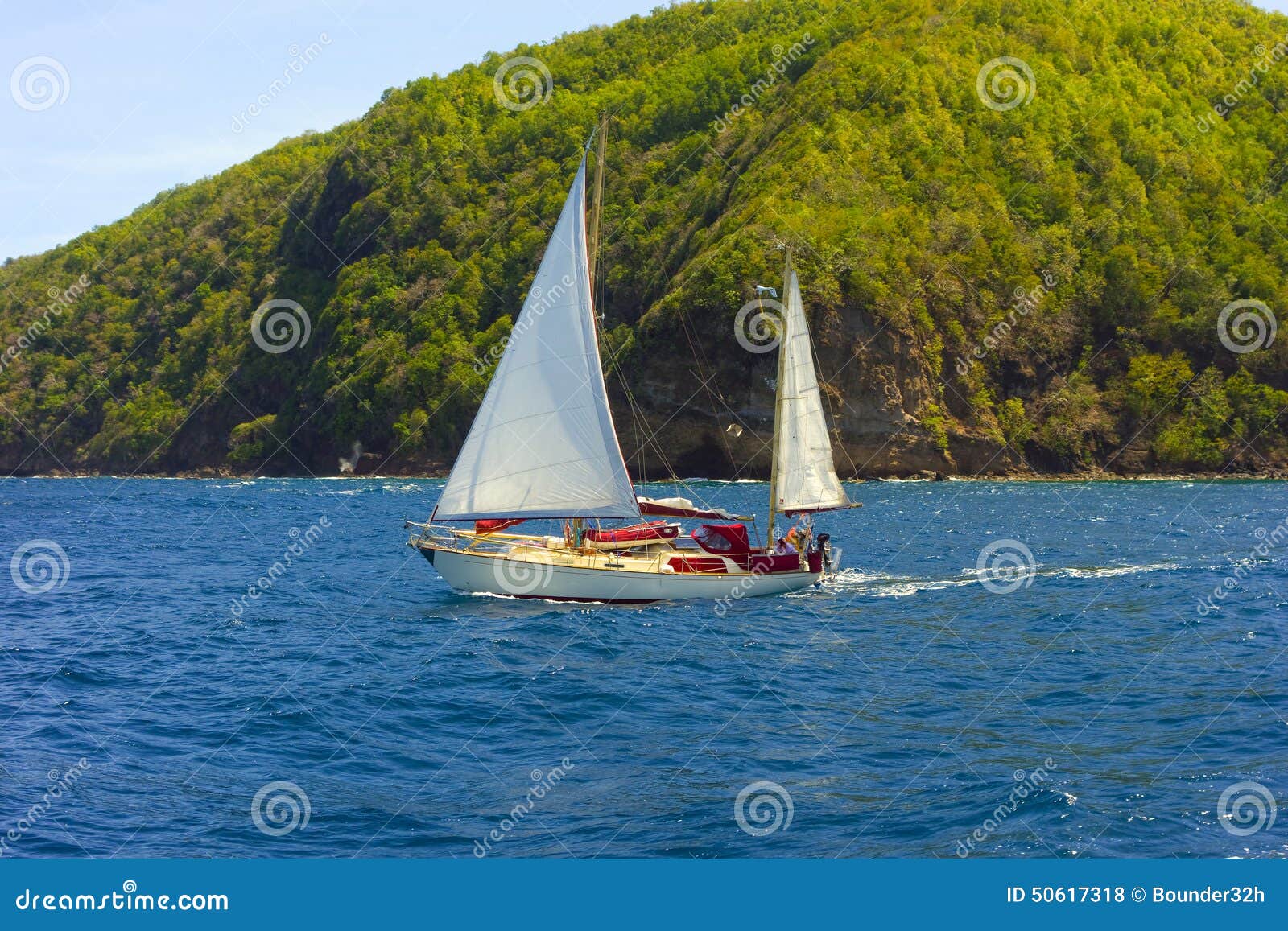 a small ketch sailing in the caribbean editorial stock