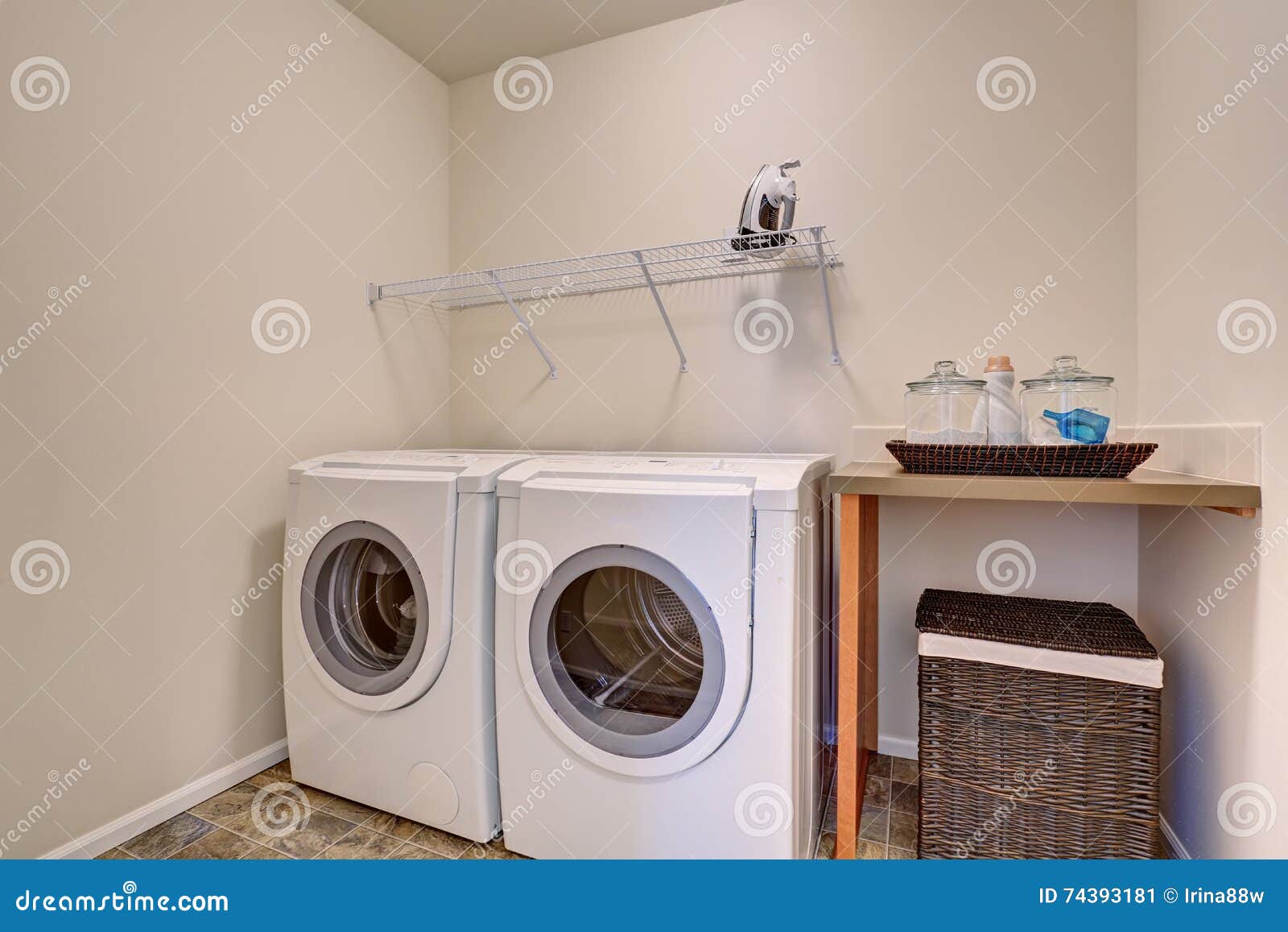 Small Laundry Room with White Appliances and Wicker Basket Stock Image