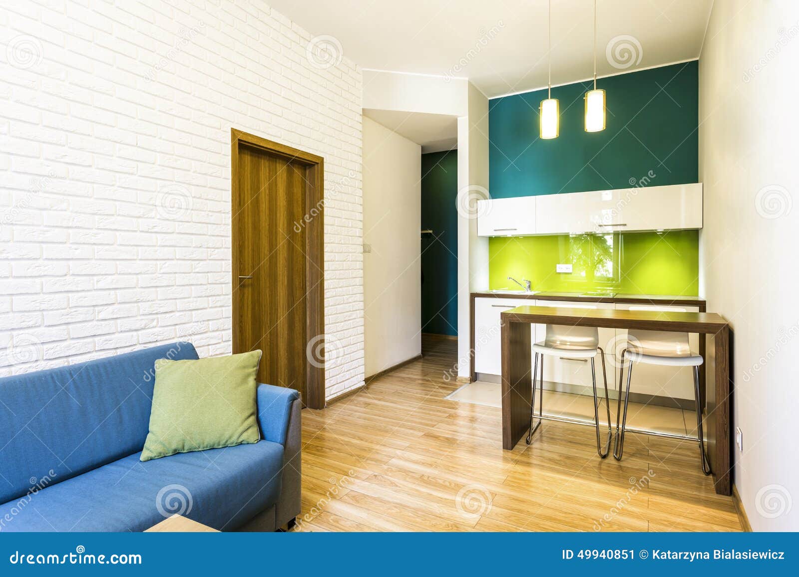 small living room with green kitchenette