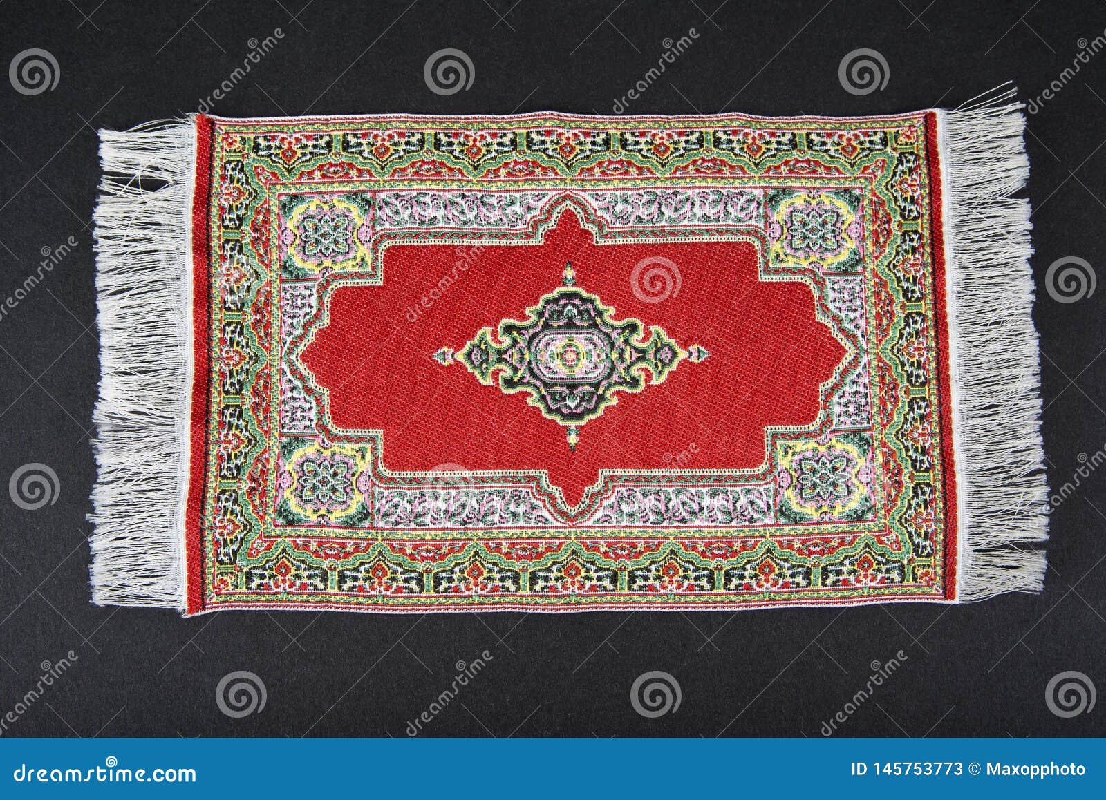Small Oriental Carpet Miniature on a Black. Stock Image Image of