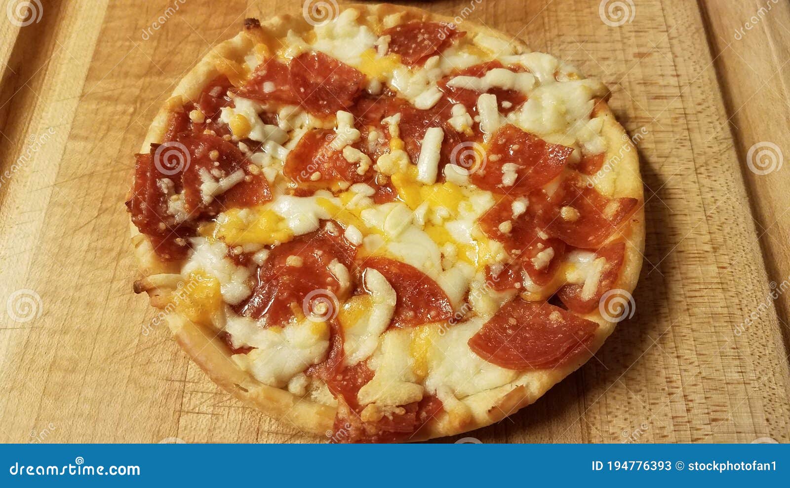 Small Pepperoni and Cheese Pizza on Cutting Board Stock Image Image