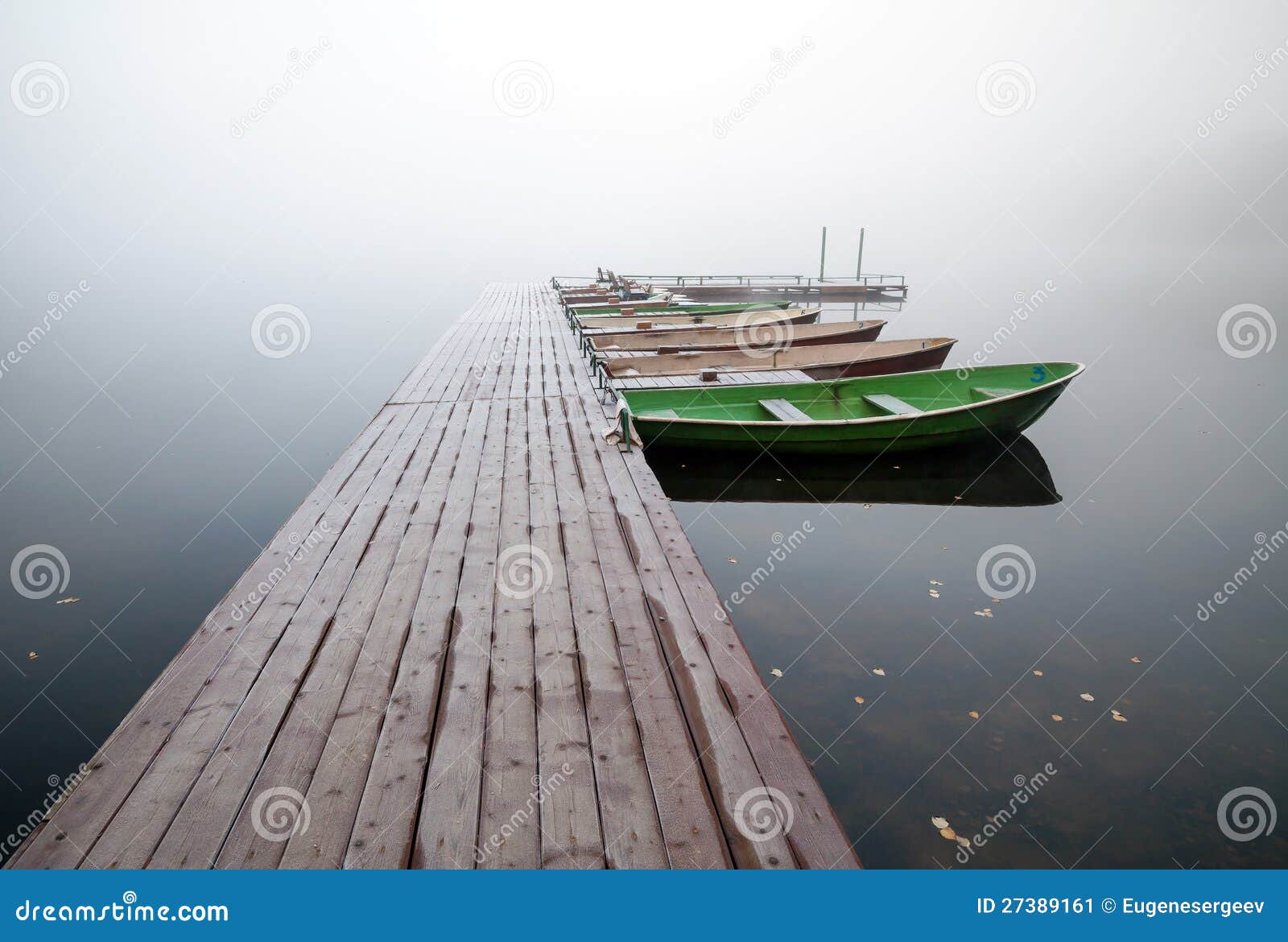 Small Pier With Boats On Lake In Foggy Morning Stock Image ...