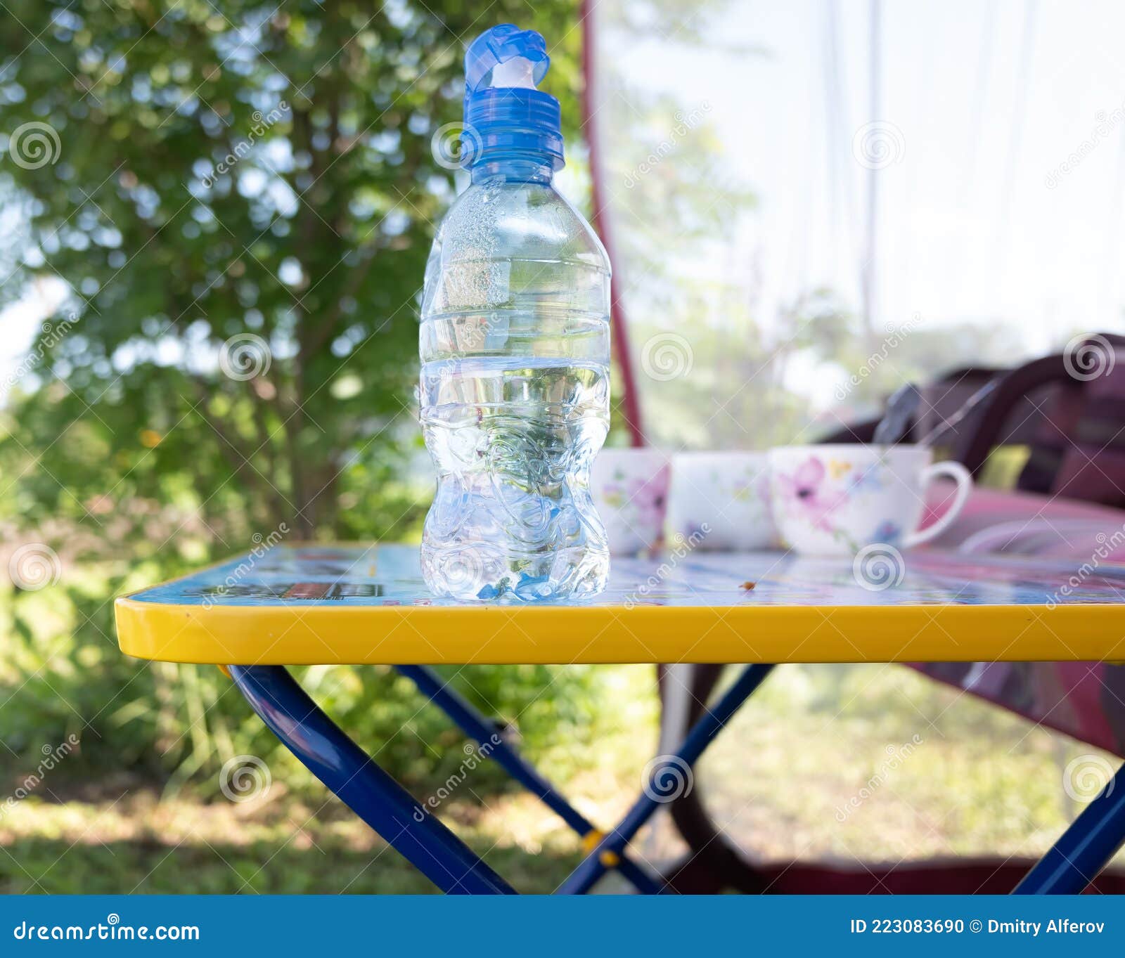 Small Plastic Water Bottle on the Table. Outdoor Recreation Concept