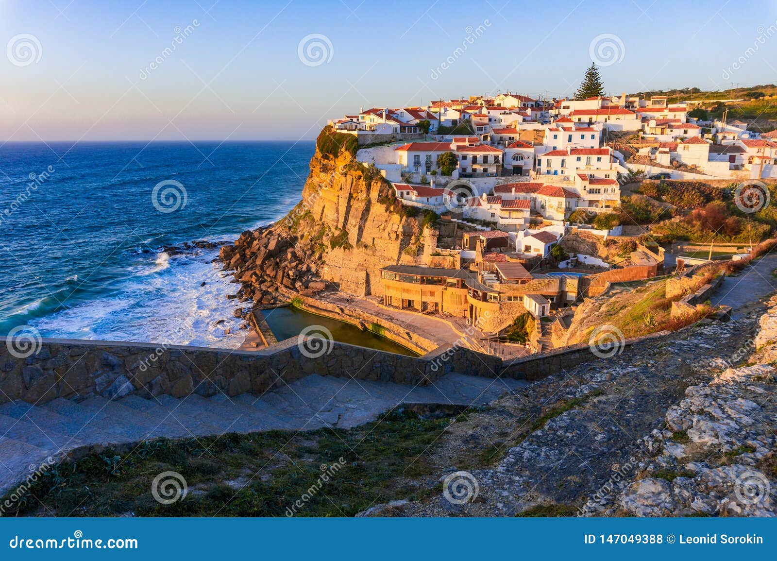small portugal village azenhas do mar on cliff on coastline with sunset