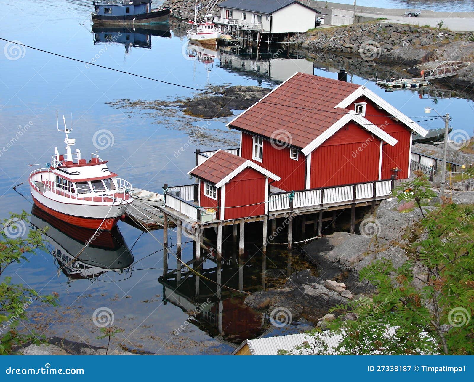 small red house with boat in moskenes, lofoten