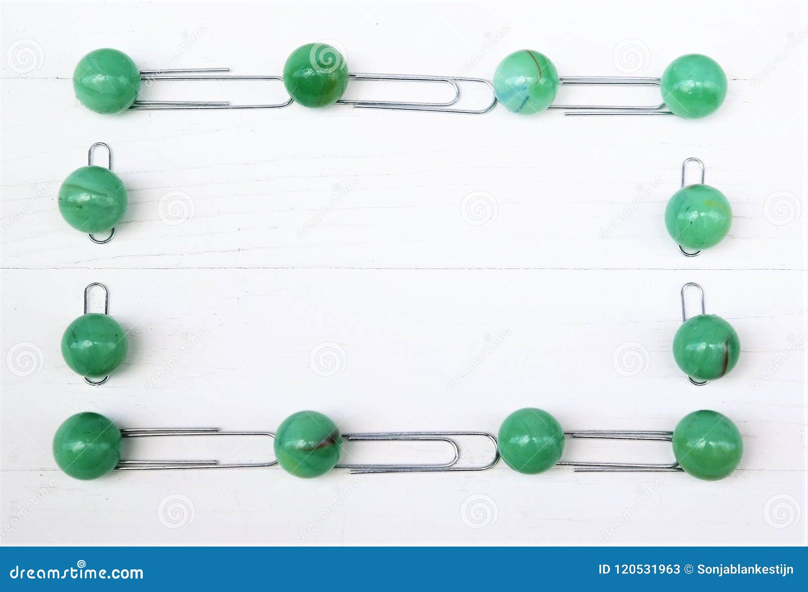 Frame of Green Marbles Balls and Metal Paperclips, White Wooden