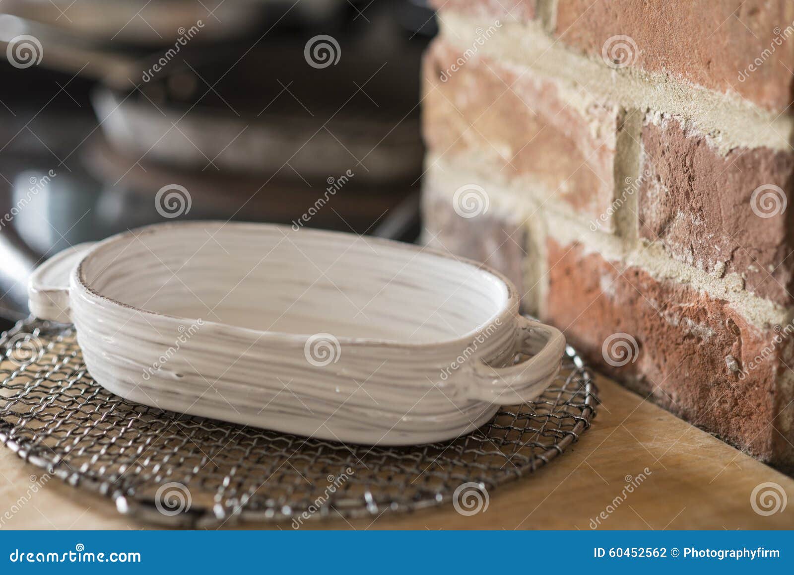 Small Rounded Rectangular Baking Dish on a Wire Trivet Stock Photo