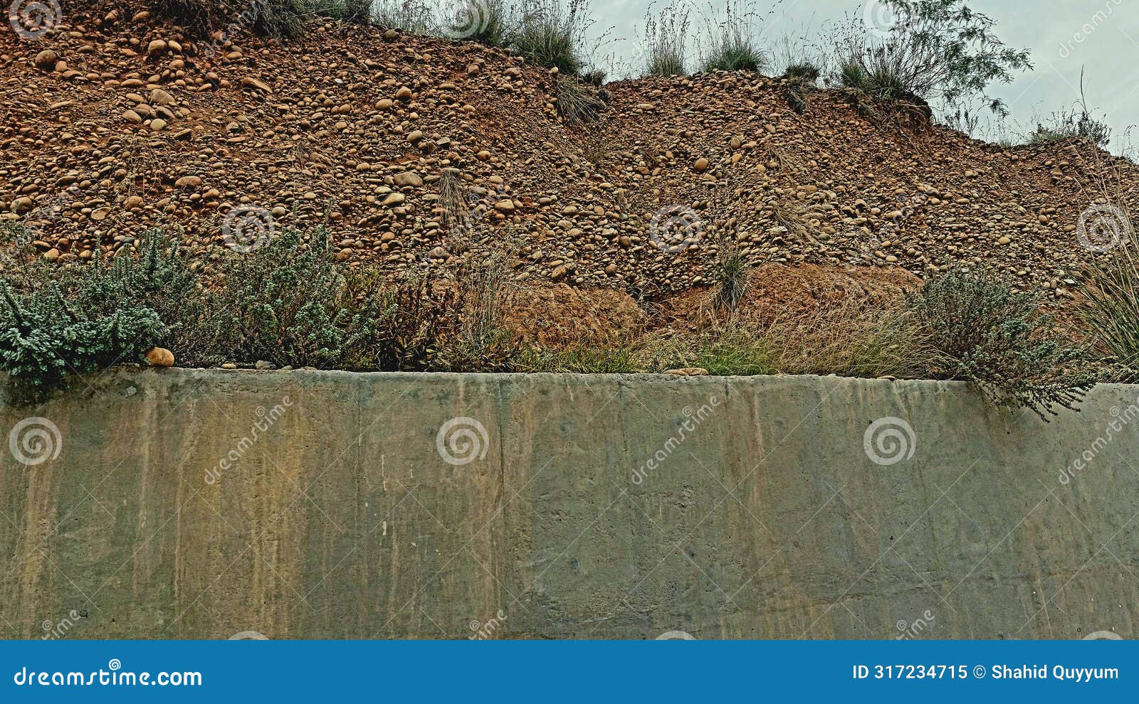 small stones wall alongside road