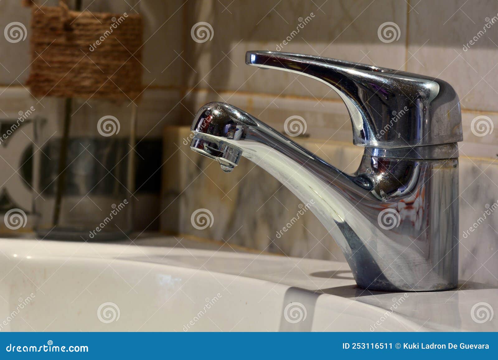 small stream of water falling from a sink faucet