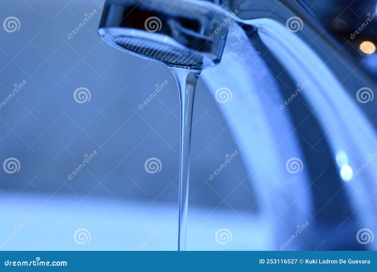 small stream of water falling from a sink faucet