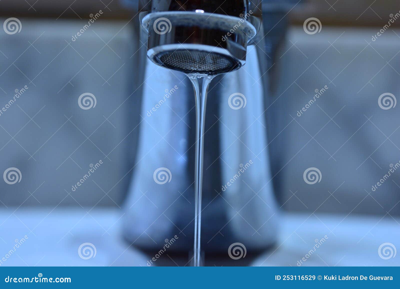 small stream of water falling from a sink faucet