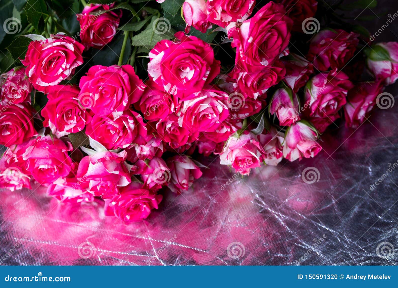 Small Striped Roses Lying in a Large Bouquet on the Reflecting Stock