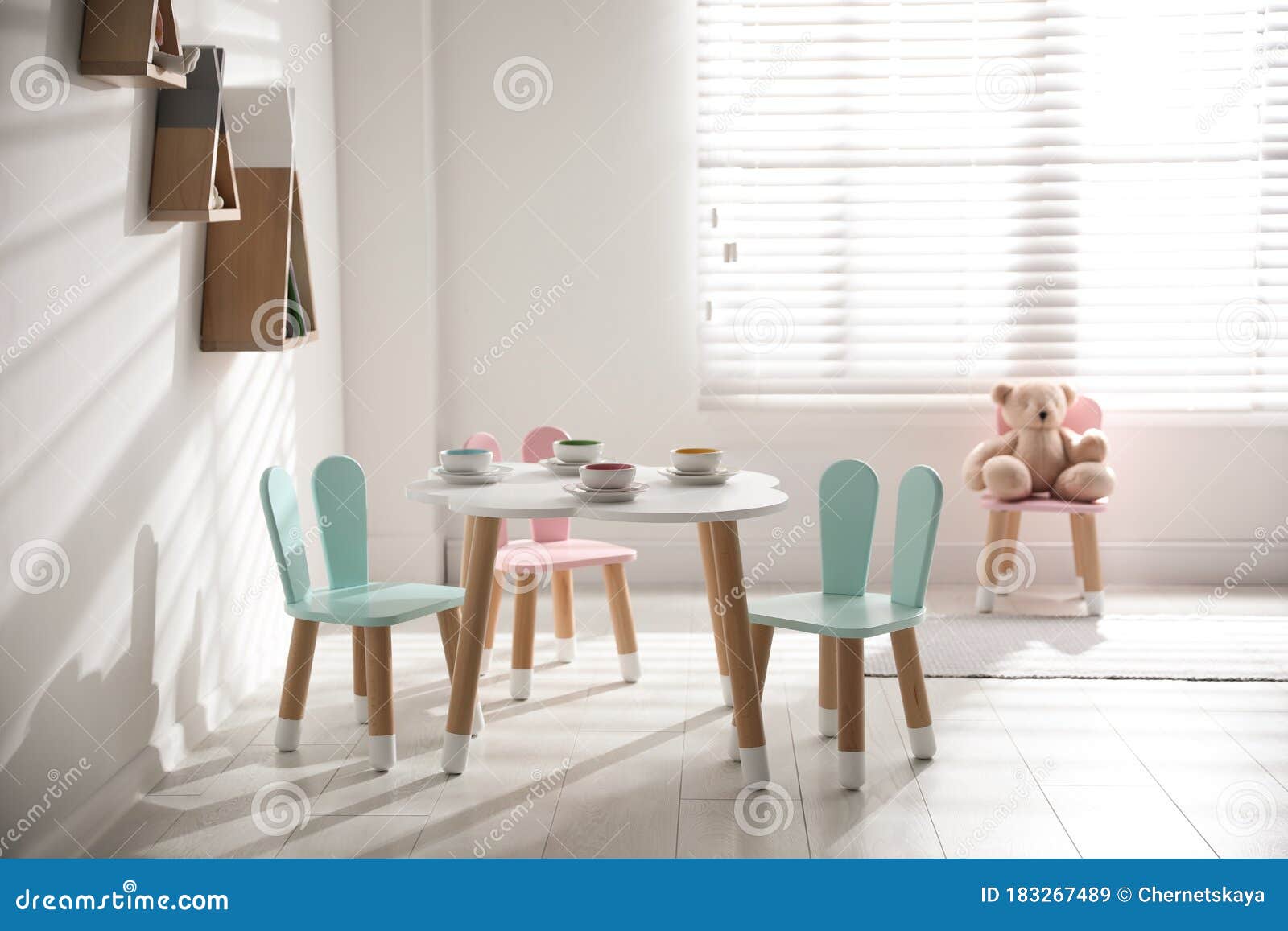 Small Table and Chairs with Bunny Ears. Children`s Room Interior Stock