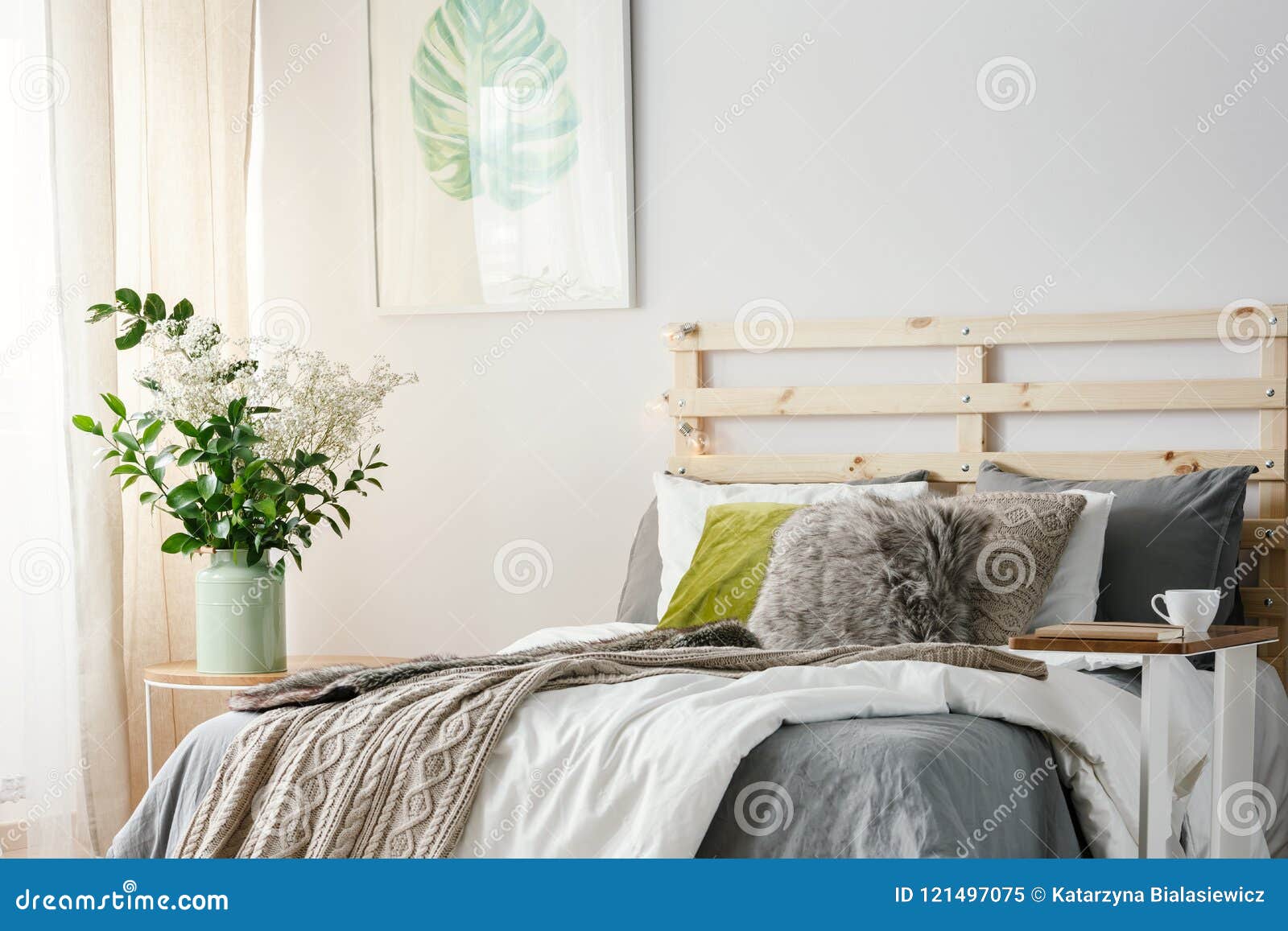Small Table with Notebook and Coffee Cup Standing by the Kingsize Bed