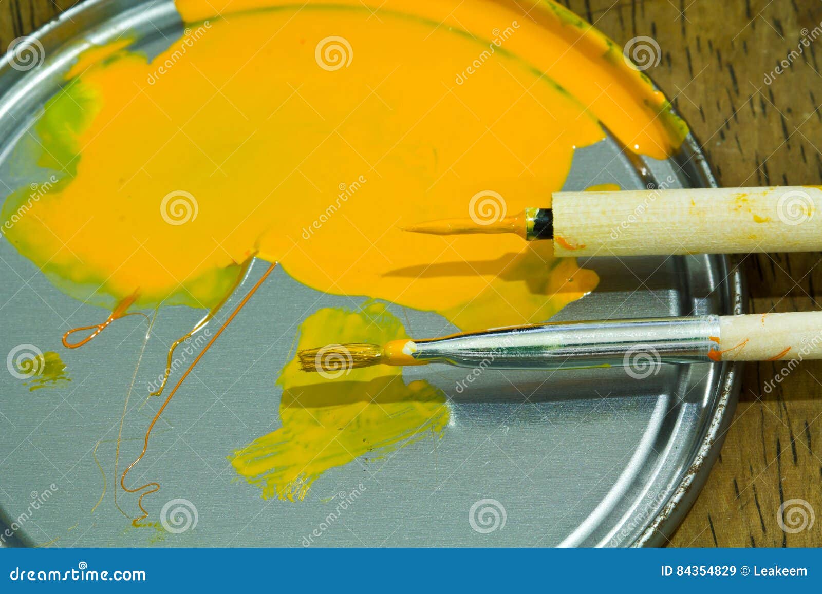 Small Thin Paintbrush And Wide Paintbrush With Paint On A Palette Stock