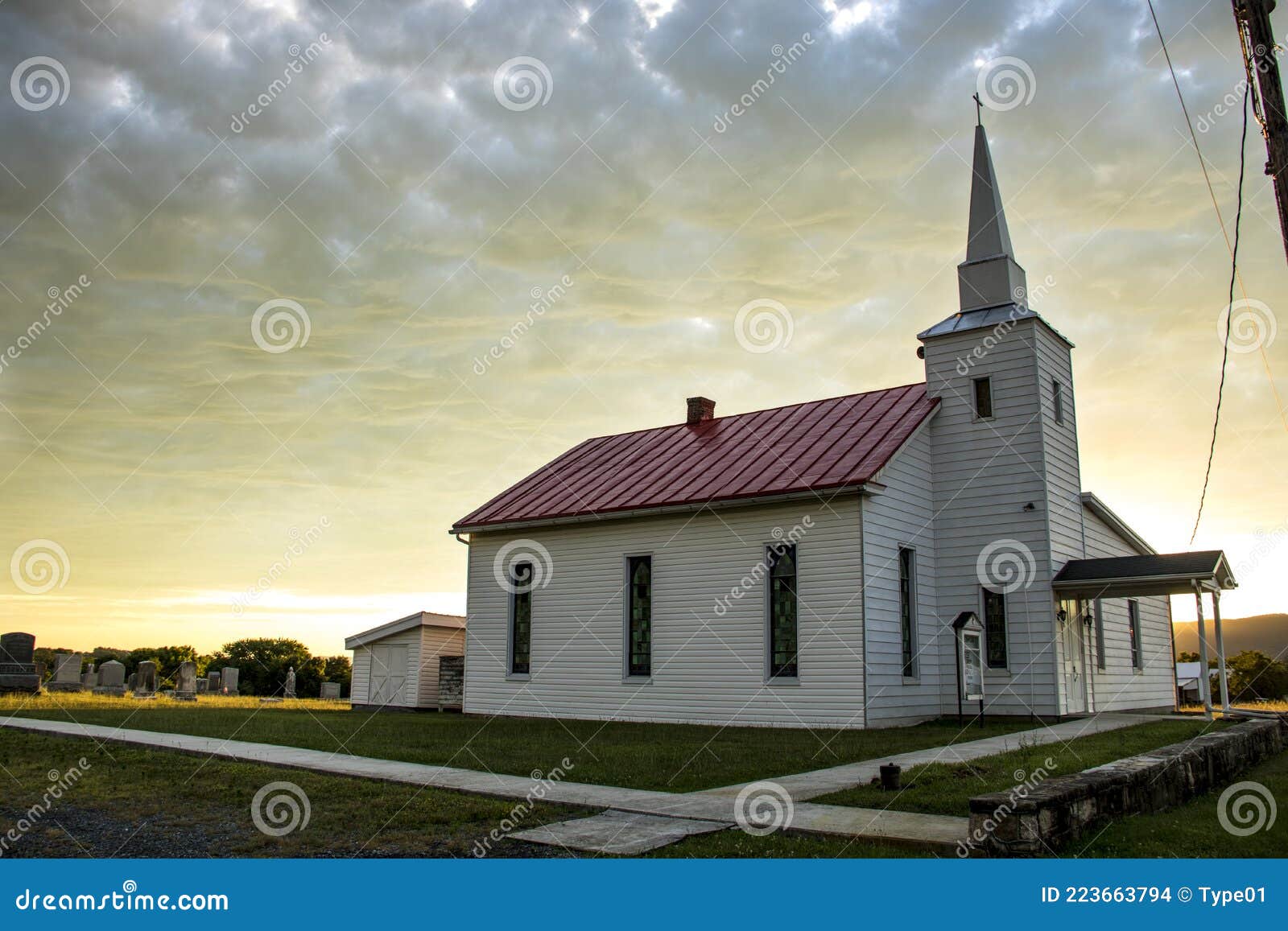 small town church and cemetery with sun lite clouds