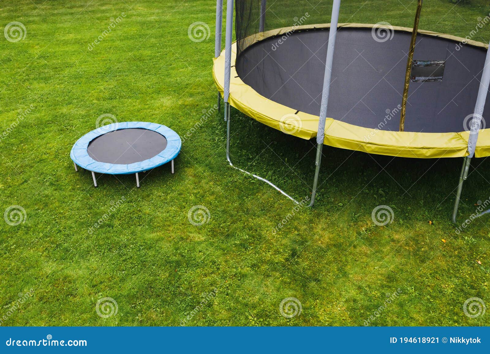 Small Trampoline On Big Round Mat, Size Comparison, Green Lawn