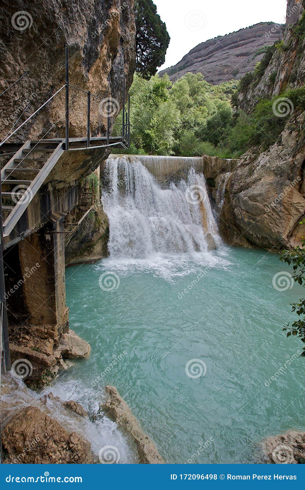 small turquoise waterfall in a river