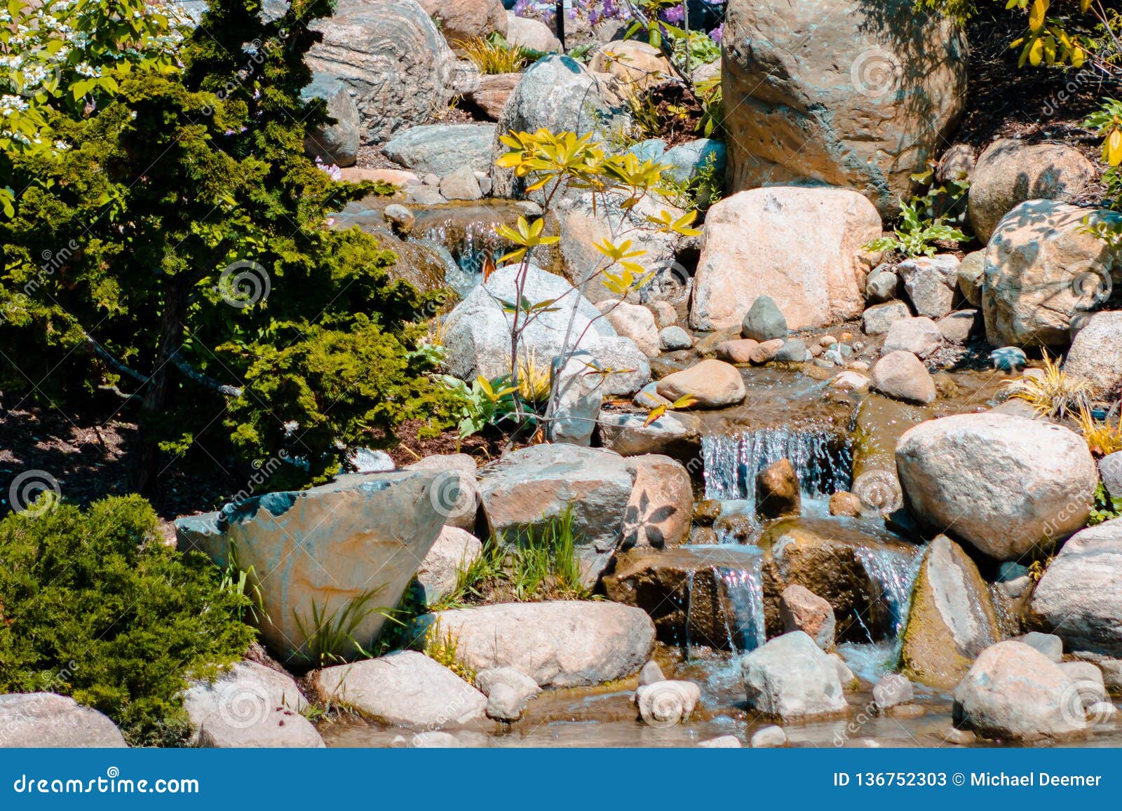 Small Waterfall Flowing Into A Pond At The Japanese Gardens In Grand