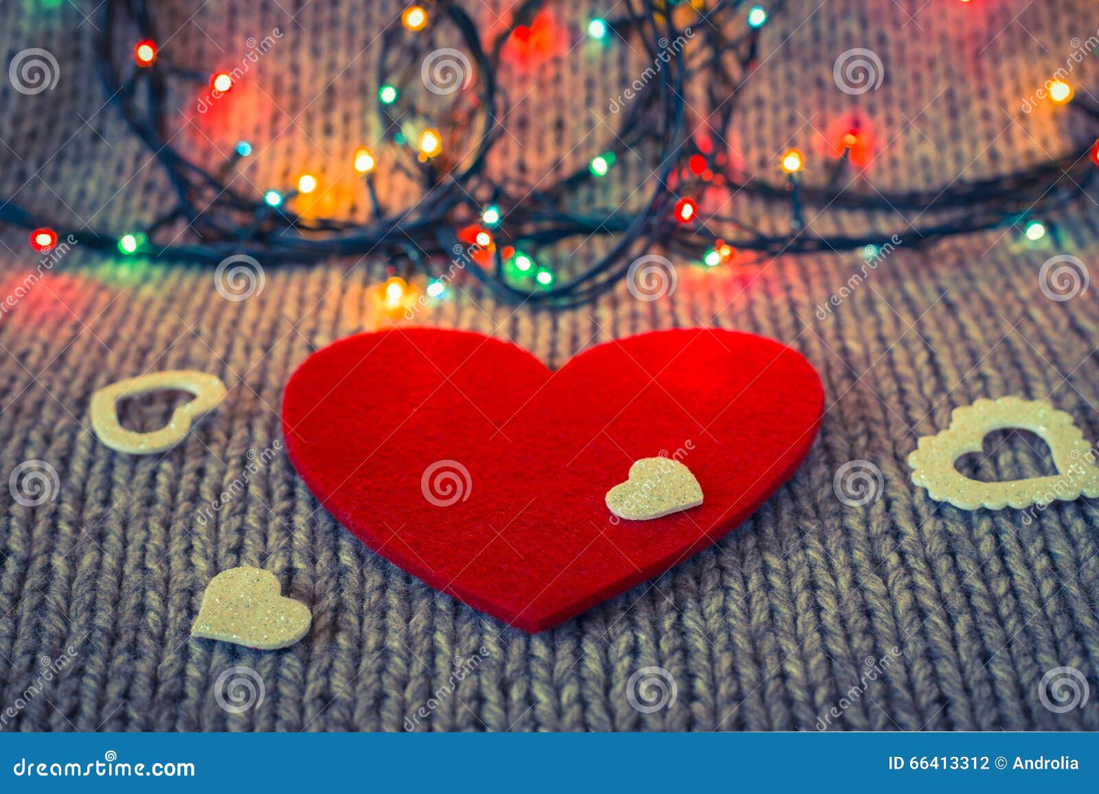 small white decorative heart on a red felt heart