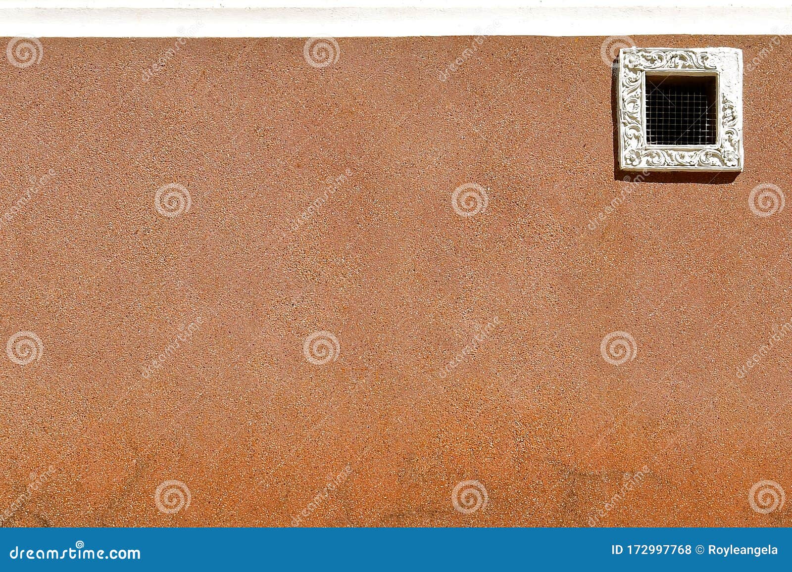 small window and pebbledashed wall