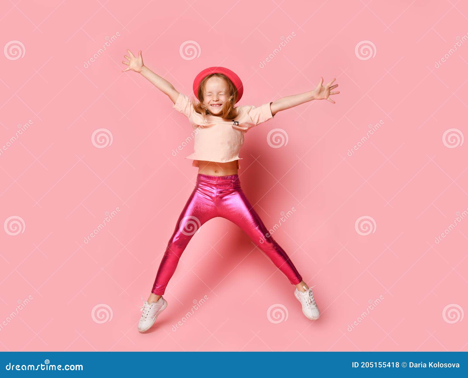 Small Woman in a Hat, T-shirt, Leggings, and White Sneakers. she Smiles and  Jumps Up with Her Eyes Closed. Posing on a Pink Stock Photo - Image of  european, leggings: 205155418