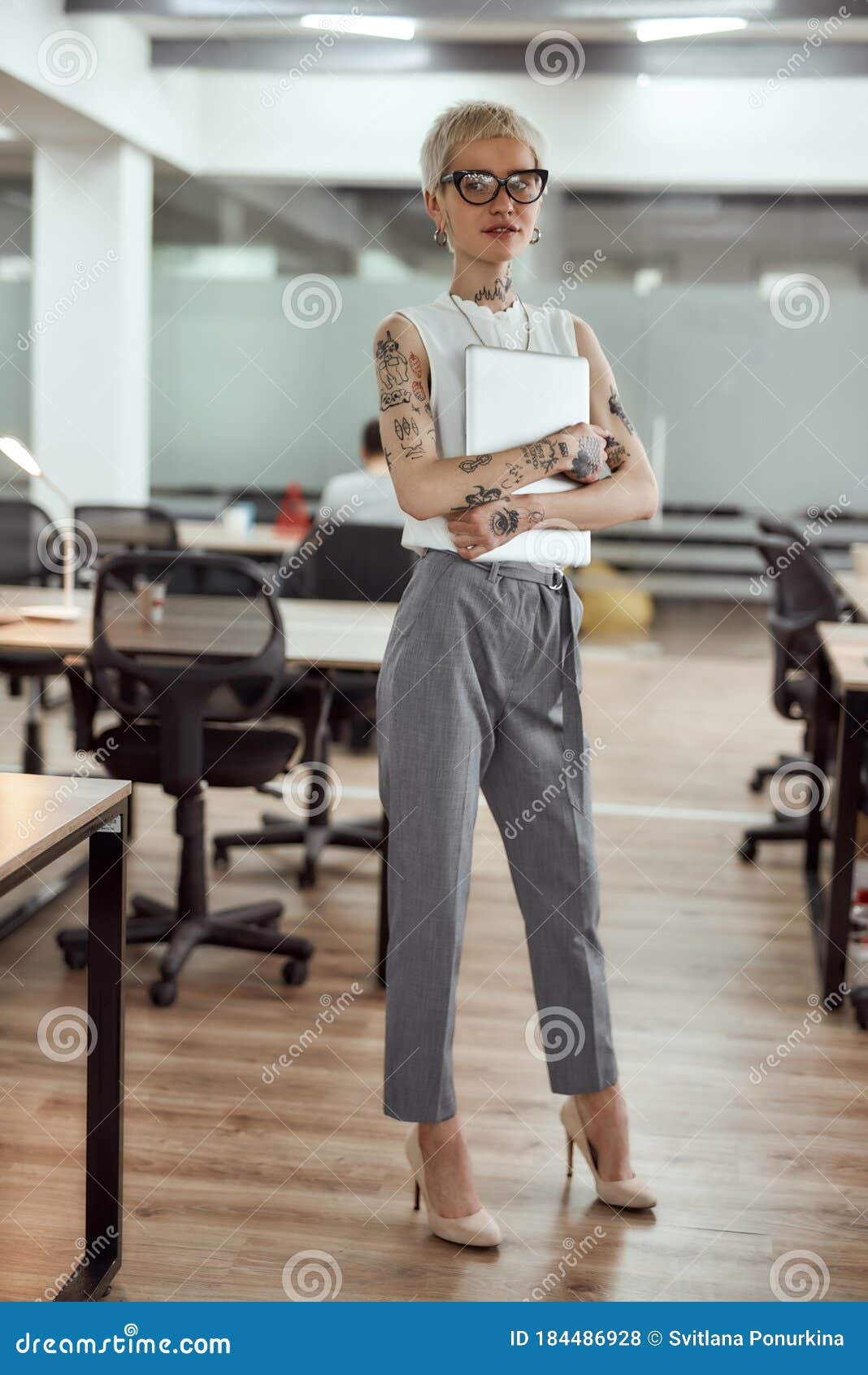 Smart Beauty. Young, Stylish and Attractive Tattooed Business Woman Holding  Her Laptop and Looking at Camera while Stock Photo - Image of internet,  room: 184486928