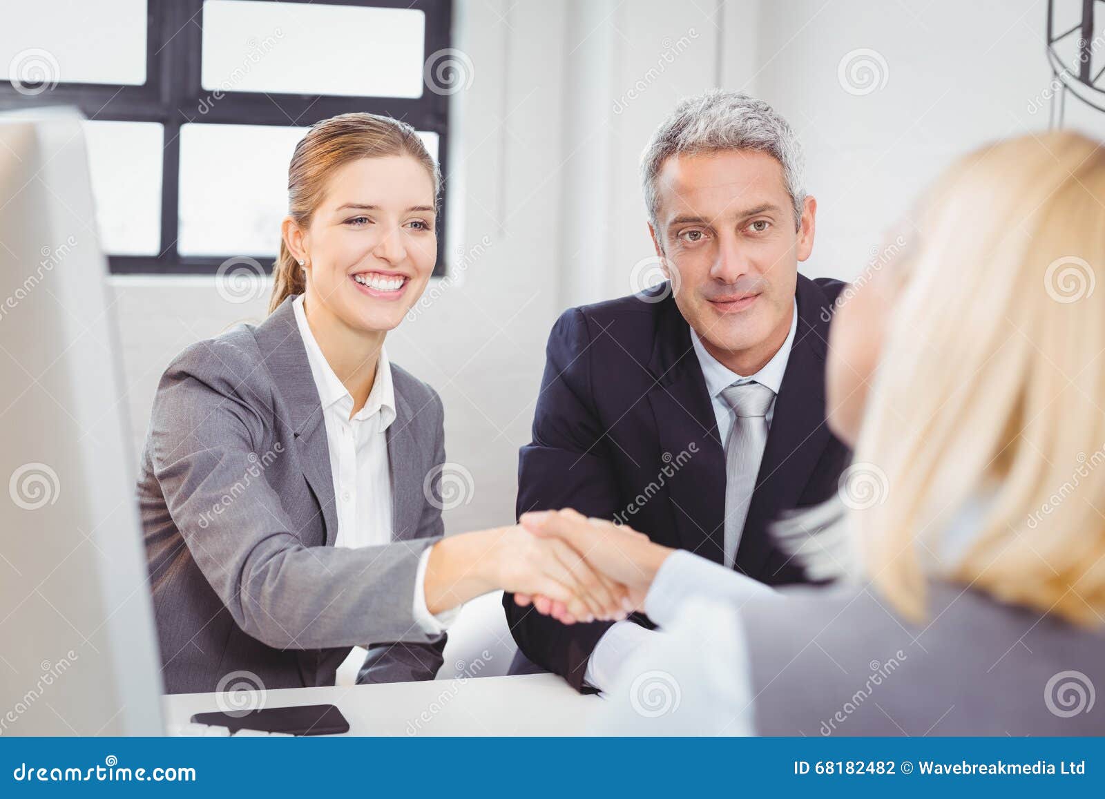 Smart Business People Handshaking With Client Stock Photo