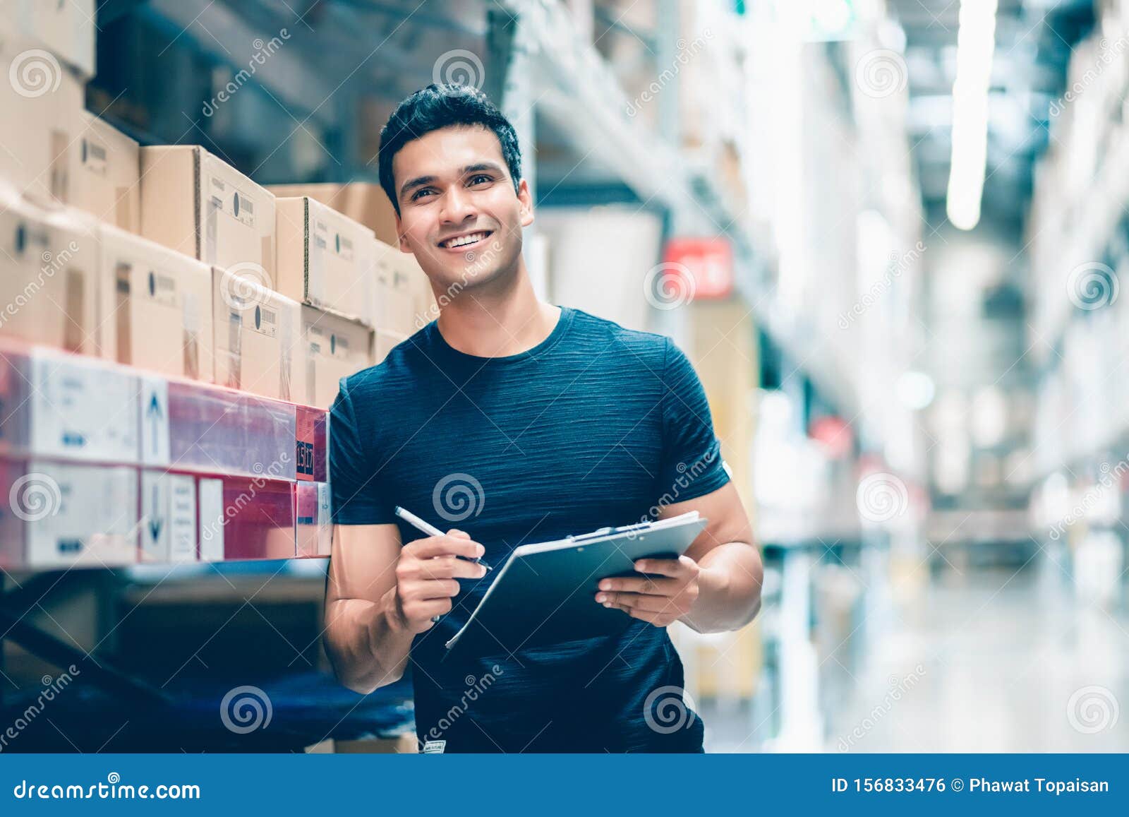 smart indian engineer man worker doing stocktaking of product management in cardboard box on shelves in warehouse.