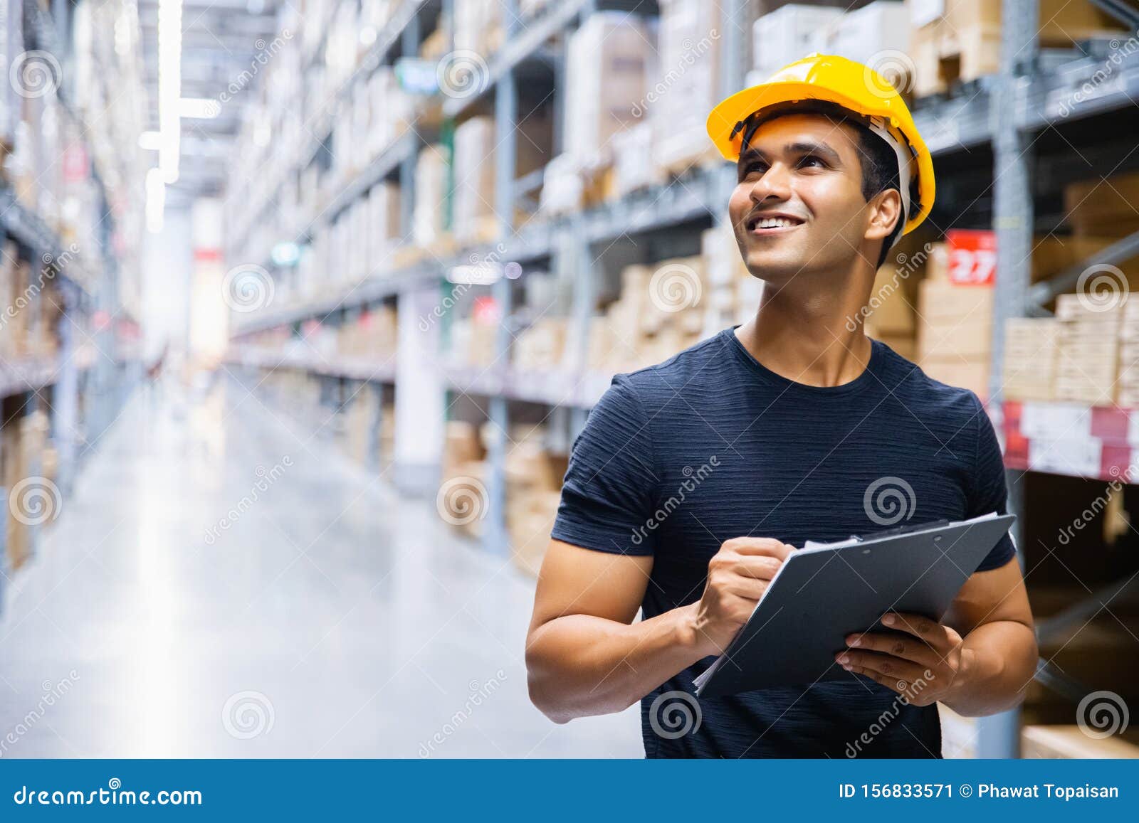 smart indian engineer man worker wearing safety helmet doing stocktaking of product management in cardboard box on shelves