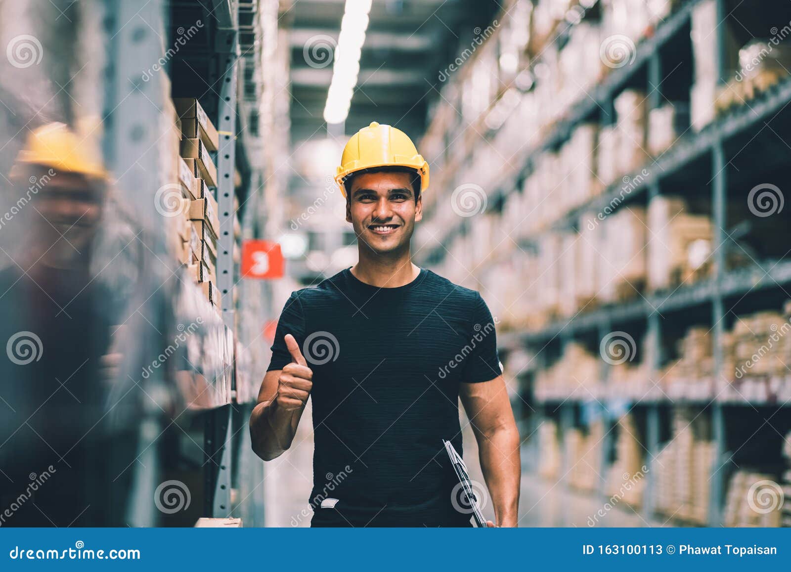 smart indian engineer man worker wearing safety helmet doing stocktaking of product management in cardboard box on shelves