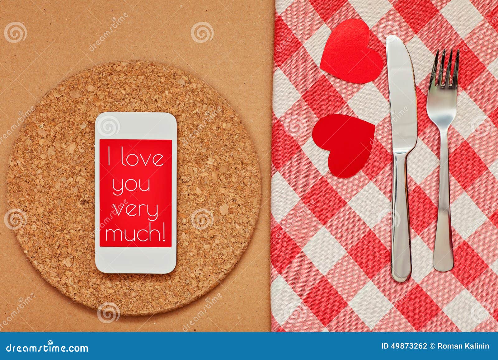 Smart Phone on the Kitchen Table with Fork and Knife for a Declaration