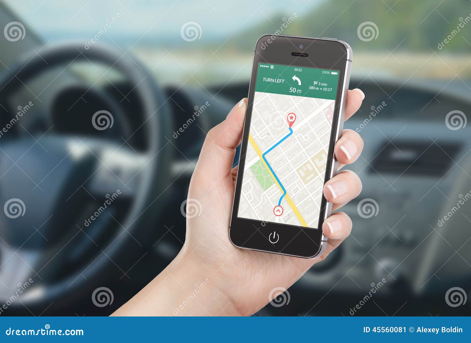 Smart phone with map gps navigation application on the screen. Female driver sitting in the car and holding black mobile smart phone with map gps navigation application with planned route on the screen. Blurred car interior on the background.