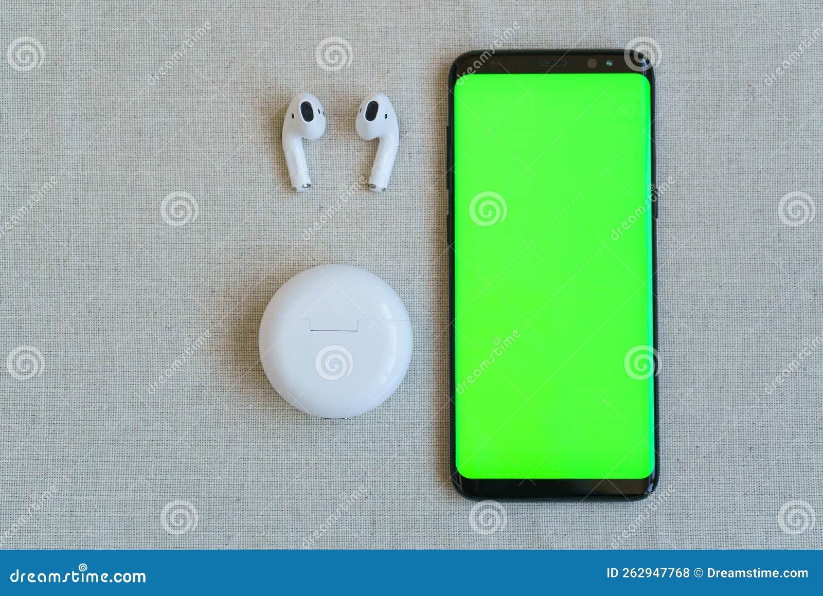 Smart Phone and Wireless Headphones with Charging Case Stock Photo