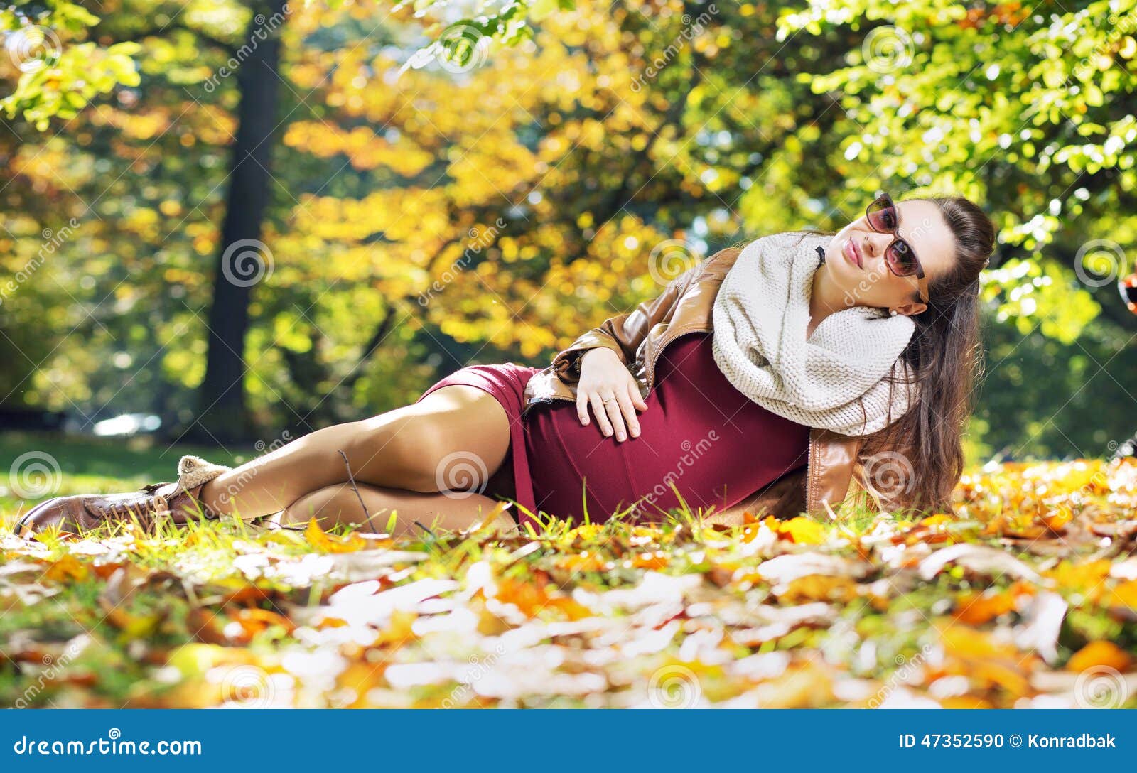 Smart pregnant woman in the autumn park. Smart pregnant mother in the autumn park