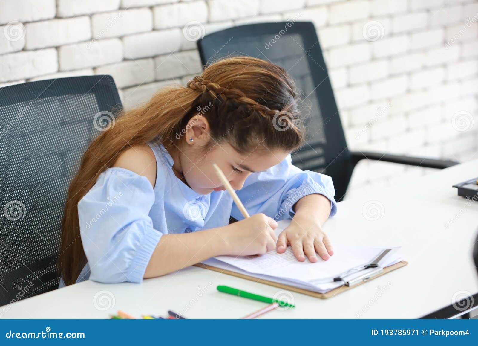 Smart School Girl Drawing in Class Education Concept Stock Image