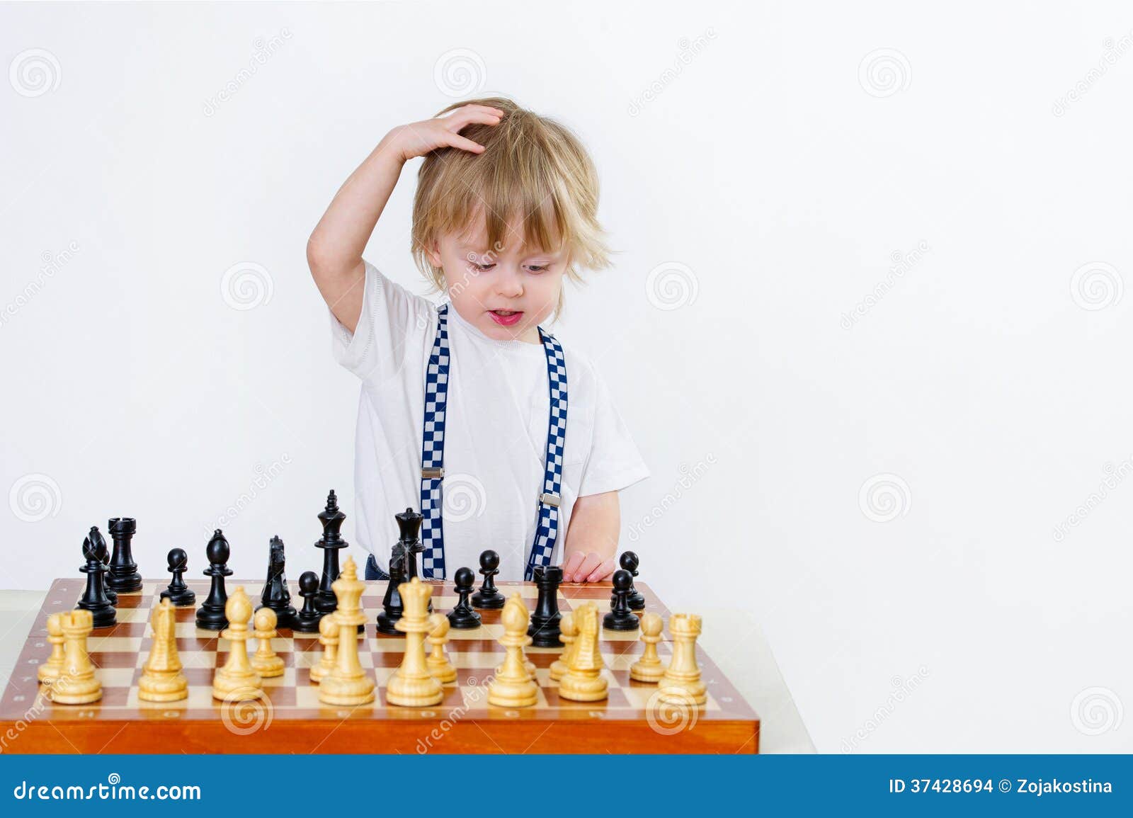 Children's Restraining Hand Thoughtfully Figure Before The Next Chess Move  Stock Photo, Picture and Royalty Free Image. Image 77247675.