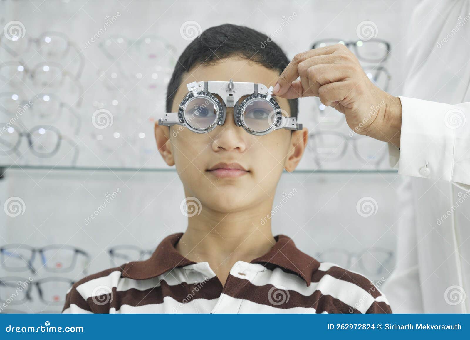 Young Boy Examining Eyesight in Optical Clinic. Stock Photo Image of