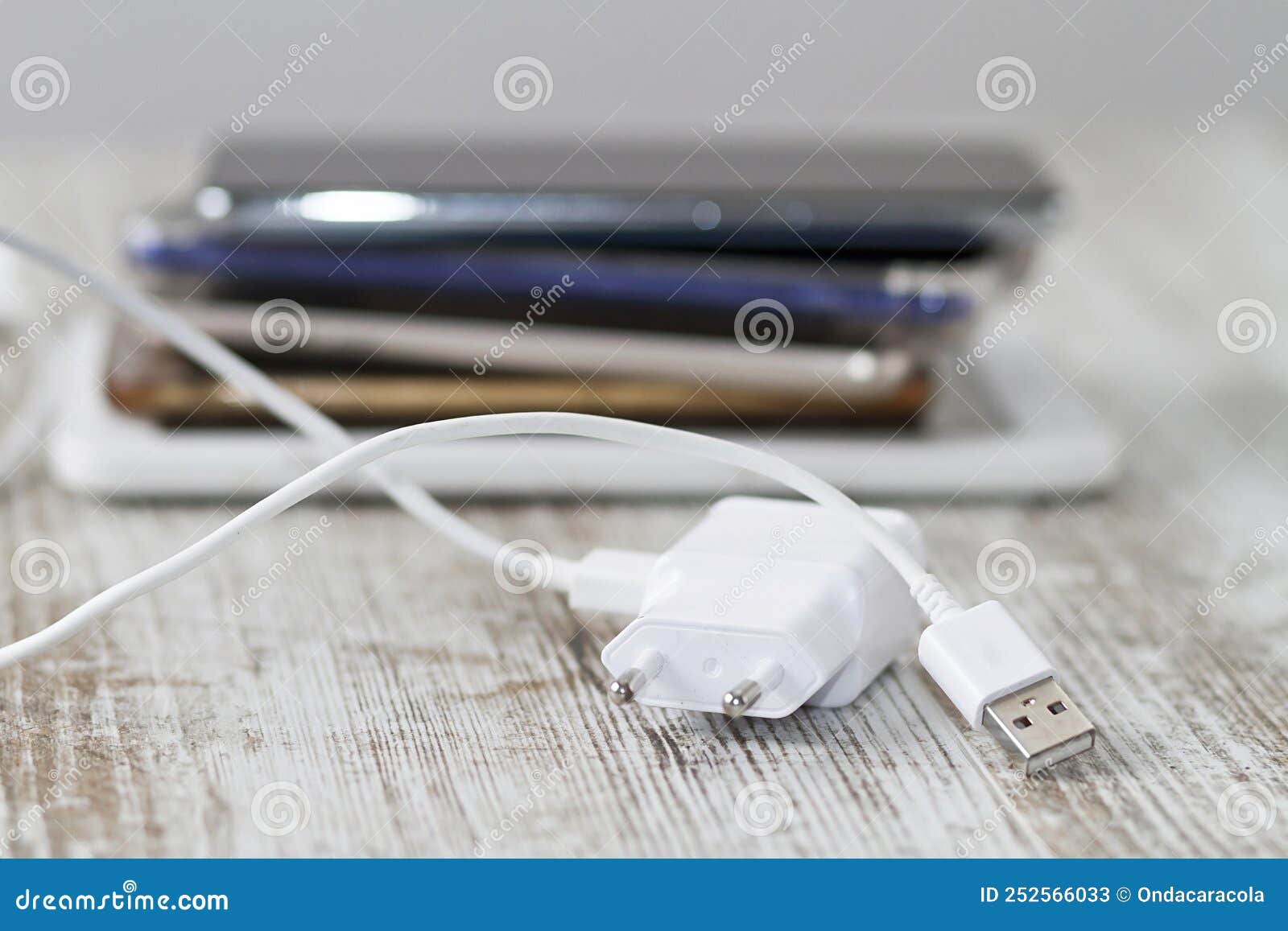 Smartphones pile and cable stock image. Image of phone 252566033