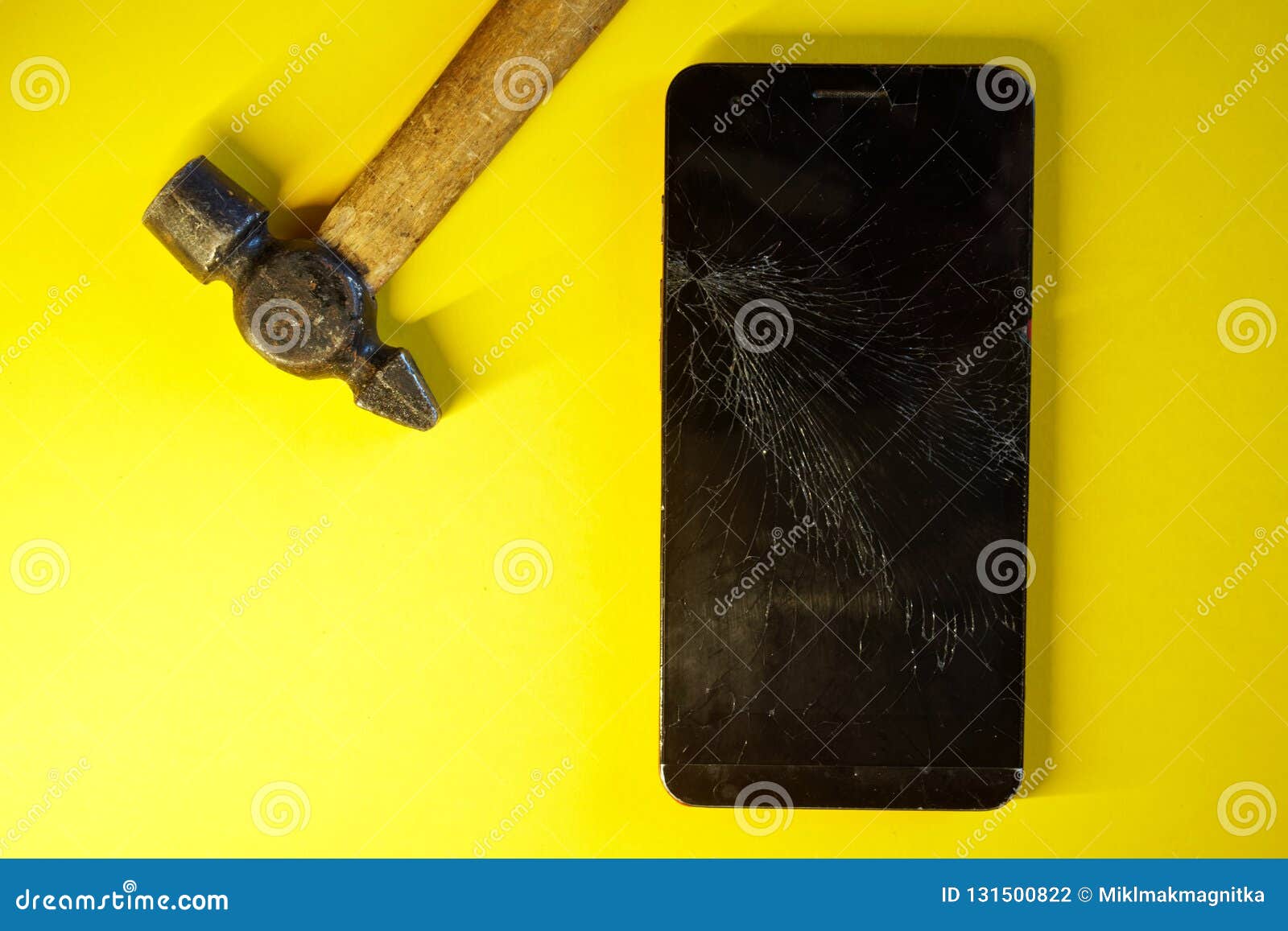 Smartphone with a Broken Display and a Hammer Stock Photo Image of