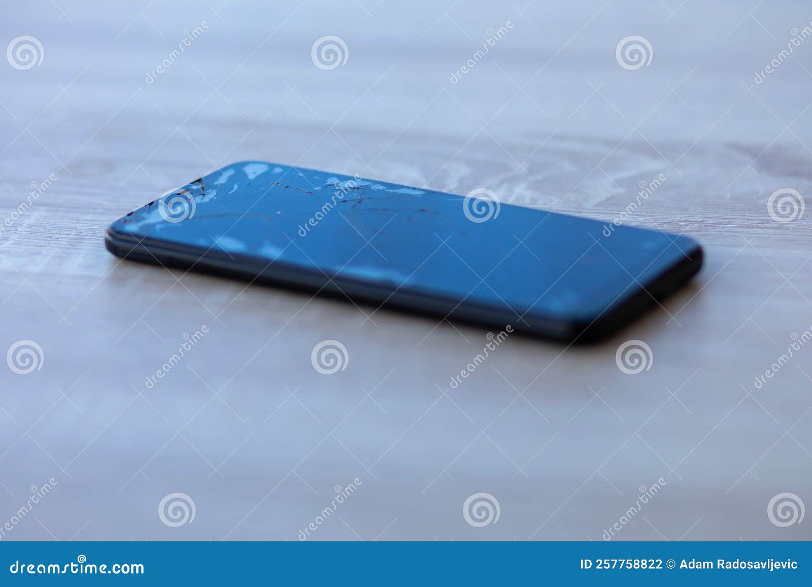 Smartphone with Broken Touchscreen Screen on Table Desktop Stock Photo